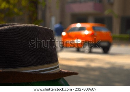 Picture of a hat and an orange car