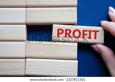 Profit symbol. Concept word Profit on wooden blocks. Businessman hand. Beautiful deep blue background. Business and Profit concept. Copy space.