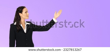 Ad photo - happy smiling woman wear confident suit, show aside, advertise copy space. Business concept. Violet purple color background. Profile side executive businesswoman. Wide banner composition.