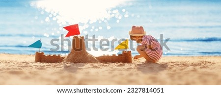 Little boy building sand castle on the sea beach. Royalty-Free Stock Photo #2327814051