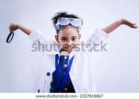 Child, happy and portrait of a scientist girl in studio with open hands, glasses and a magnifier. Face of a African kid student excited for medical science, education or biology experiment for future Royalty-Free Stock Photo #2327818867