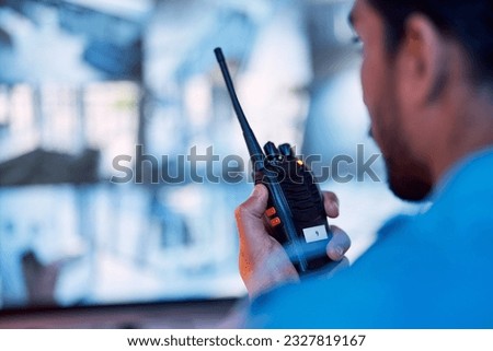 Security guard, radio and cctv monitor, communication and inspection service for building safety. Screen, video surveillance agency and law officer in control room talking on two way intercom system. Royalty-Free Stock Photo #2327819167