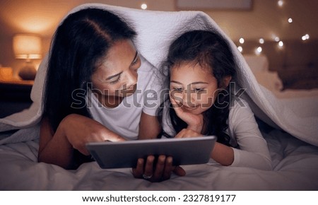 Mother, child and tablet with blanket at night in home for online games, reading ebook story and movies. Happy mom, girl kid and streaming cartoon on digital technology, media connection and bedroom