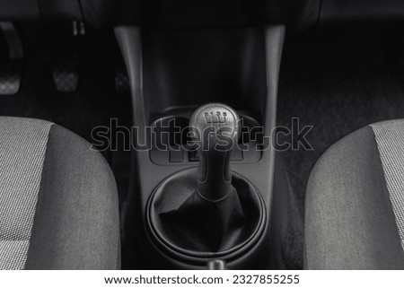 A gear level inside the car Skoda Fabia. Modern compact city Czech car. A black car interior with the gear level inside the car with natural light. Manual transmission driving. Cars and Parking Royalty-Free Stock Photo #2327855255