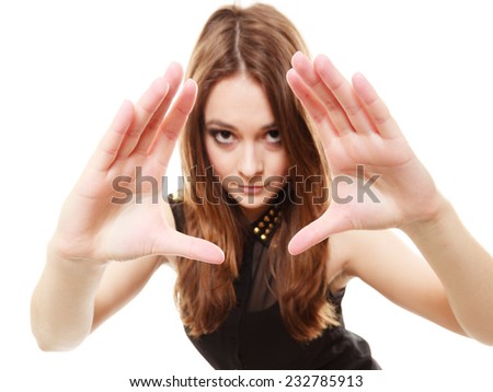 Young people teenage concept - stylish young model funny teenager girl making creating frame with fingers on white
