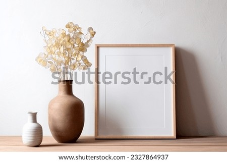 Frame and poster mock up in living room with clay vase and dried flowers. Scandinavian interior.
