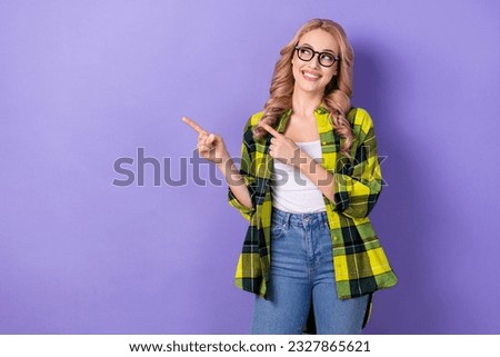 Portrait of cute office worker lady look direct fingers empty space wear computer eyewear shirt jeans isolated violet color background