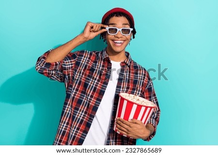 Photo portrait of handsome young man touch 3d glasses excited watch film dressed stylish checkered outfit isolated on cyan color background