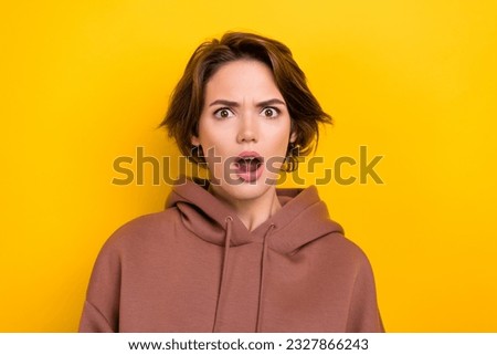 Photo of upset annoyed confused woman with short haircut dressed brown hoodie astonished staring isolated on yellow color background Royalty-Free Stock Photo #2327866243