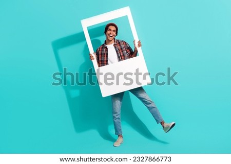 Full length portrait of carefree cheerful person dancing hold paper album card moment isolated on turquoise color background