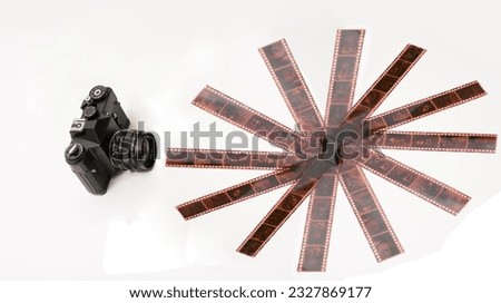 Old photo film roll and retro camera on desk. isolated on white background. Vintage 35 mm film photo camera over white. 