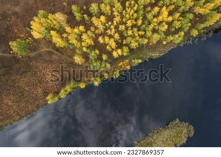 landscape autumn forest aerial view, river and forest in autumn. clouds reflecting in the water