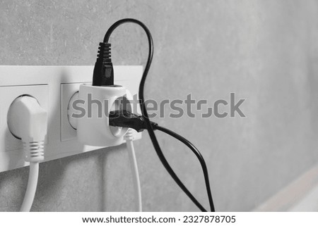 Many different electrical power plugs in sockets on grey wall indoors, closeup. Space for text Royalty-Free Stock Photo #2327878705
