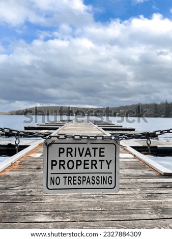 Private property sign on a dock. cloudy day at the lake