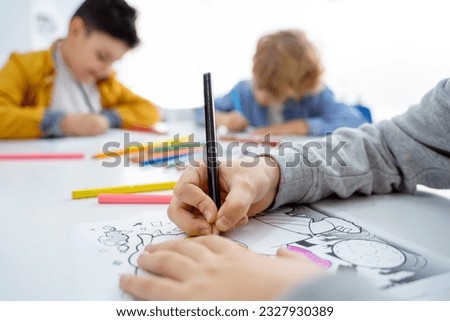 Children drawing paint with colorful pencils coloring book in educational class at school. Art creative lessons developing imagination fine motor skills Royalty-Free Stock Photo #2327930389