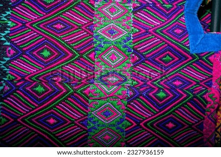 Colorful textile for sale in public space in Guatemala City, work done by indigenous hands of millenary Mayan culture, handicraft work economy in Latin America. Royalty-Free Stock Photo #2327936159