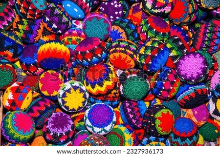 Colorful textile for sale in public space in Guatemala City, work done by indigenous hands of millenary Mayan culture, handicraft work economy in Latin America. Royalty-Free Stock Photo #2327936173