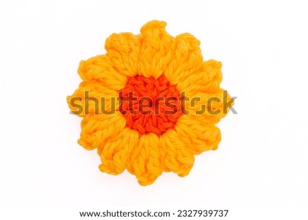 Colorful flower knitted with crochet, as hair clips, on a white background, isolated Royalty-Free Stock Photo #2327939737