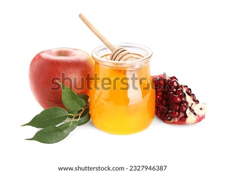 Jar of sweet honey, ripe apple and pomegranate on white background. Rosh hashanah (Jewish New Year) celebration Royalty-Free Stock Photo #2327946387