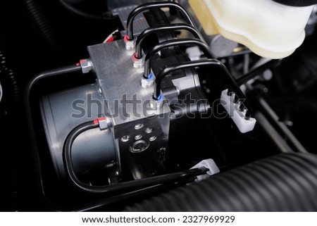 ABS motor control module in the car ( anti-lock brake system). braking system control motor Royalty-Free Stock Photo #2327969929