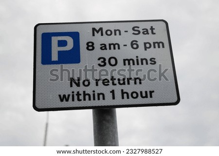Village parking sign "Mon - Sat 8am - 6pm 30 mins no return within 1 hour" UK