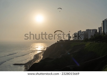 Paragliding during the Sunset in la Costa Verde (Green Coast) in Lima, Peru