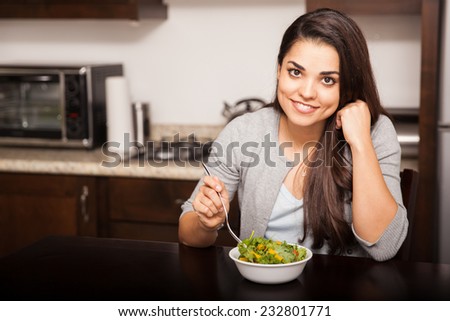 Beautiful Hispanic young woman enjoying a healthy salad for lunch