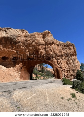 tunnel in the rock.  road through the red rock.  travel road in the rock