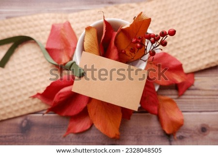 Autumn concept background. Autumn leaves, blank tag and cup and saucer composition for seasonal background. Fall, Thanks giving.