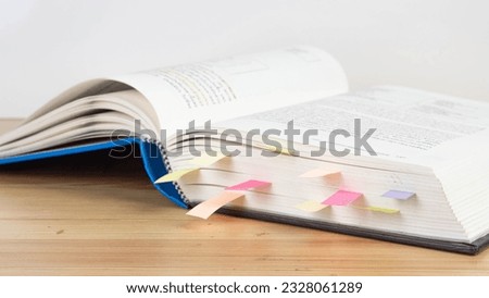 Book instruction manual reference sticky paper note blur background.