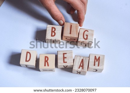 English vocabulary "BIG DREAM" with medium brown wooden blocks, pink and white background
