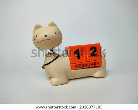 a unique february teddy cat calendar with blocks with the date and month written on it, on a white background