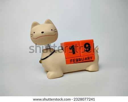 a unique february teddy cat calendar with blocks with the date and month written on it, on a white background