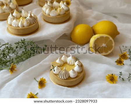 Dessert on a white plate. Free space for text. Yellow flower background. Menu cafe and coffee shop. Lemon Meringue Tart is tangy and sweet. 