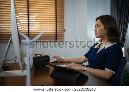 Futuristic women Engineer working with Holographic Augmented Reality and 3D Wind Turbine Model on tablet at home office ,Concept of technology and environment