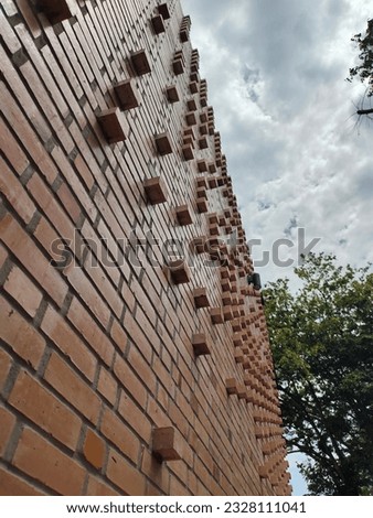 Tall block wall with sky view