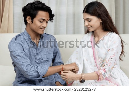 Sister tying rakhi on her brother's wrist on the occasion of Raksha Bandhan Royalty-Free Stock Photo #2328123279