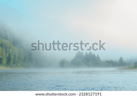 A foggy morning on a mountain river in late summer. High quality photo