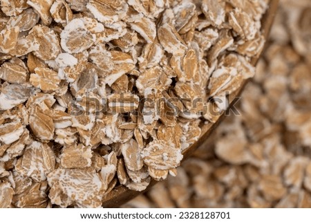 a bunch of fresh dry oatmeal flakes for making porridge, a large number of large oatmeal flakes for making breakfast Royalty-Free Stock Photo #2328128701