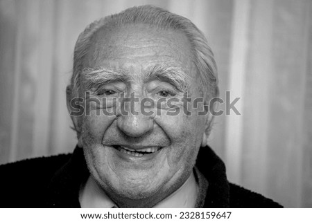 Black and white photo of grandfather smiling for life. At 89 years old, the smiles are often honest sincere and inspiring.