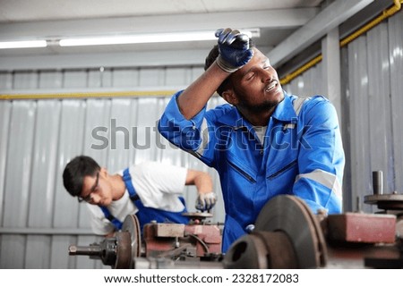 workers or technicians feeling tired from hot weather over heat in the factory Royalty-Free Stock Photo #2328172083