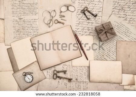 antique accessories, open book and old handwritten letters. nostalgic background