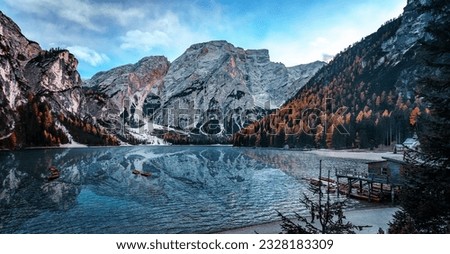 Amazing nature landscape background. Scenic image in Sunny day of the Braies Lake, Pragser Wildsee in Dolomites mountains, Italy. Impressive Lago di Braies. Iconic location for landscape photographers