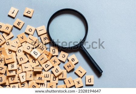 English alphabet made of square wooden tiles with the English alphabet scattered on blue background. The concept of thinking development, grammar. Royalty-Free Stock Photo #2328194647
