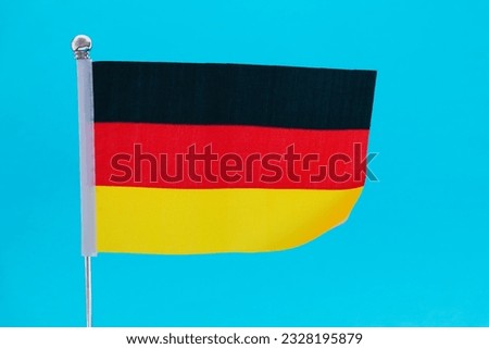 German flag waving on blue background.