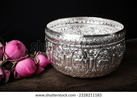 Thai garland flowering and pink lotus setting by asian style on silverware
