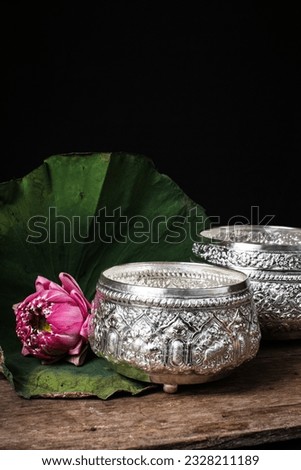 Thai garland flowering and pink lotus setting by asian style on silverware