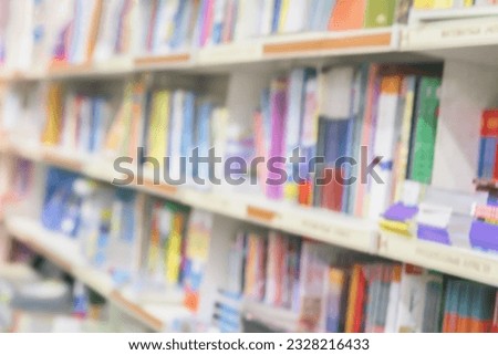 Blurred school library bookshelf with colorful book, smanuals and textbooks. Education, school, study concept. Abstract background