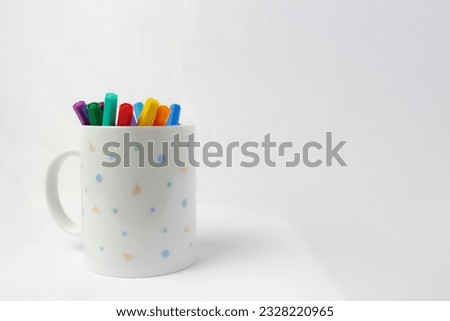 Start the new school year with a mug full of creative inspiration. This stock photo shows a mug on a white background, replete with ready-to-use colored markers. With every sip of your favorite