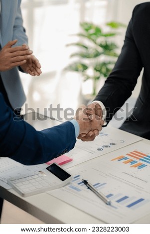 Two businessmen holding hands, Two businessmen are agreeing on business together and shaking hands after a successful negotiation. Handshaking is a Western greeting or congratulation. Royalty-Free Stock Photo #2328223003